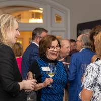 Pat Waring smiling and talking with other event guests